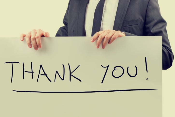 man holding sign with Thank You written on it
