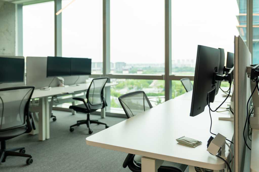 Interior of modern empty office building.Open ceiling design.Equipped with automatic lifting table and LCD screen.
